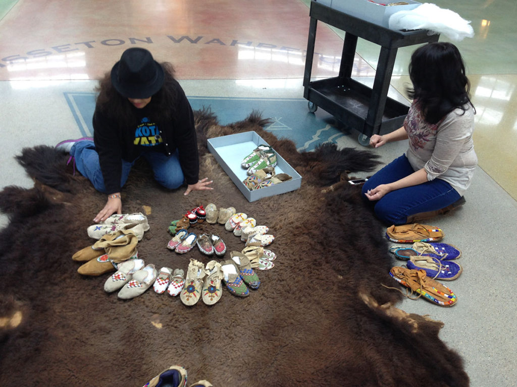 Native and non-native volunteers helping construct spiral timeline