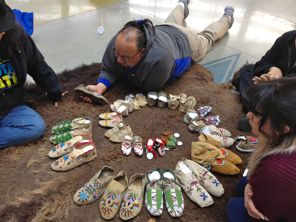 Native and non-native volunteers helping construct spiral timeline