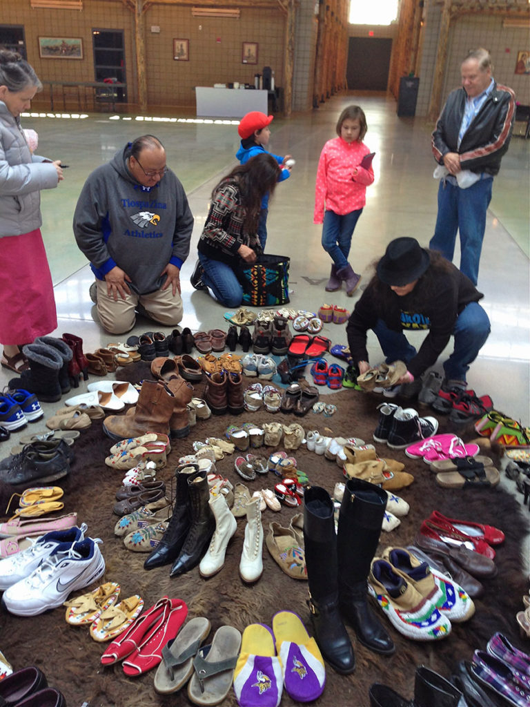 Native and non-native volunteers helping construct spiral timeline